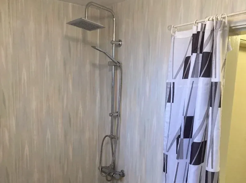 Shower with overhead shower and shower curtain