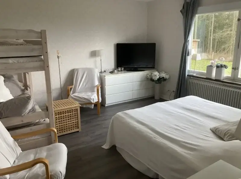 Bright room with a double bed, bunk bed and TV
